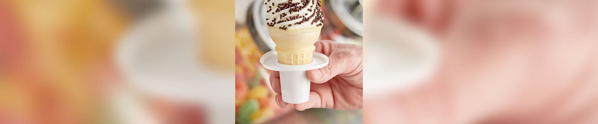 A person holding an ice cream cone in their hand.